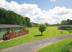 a house in the middle of a green field at Parmontley Hall Lodges in Whitfield