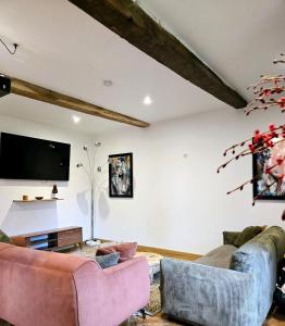 a living room with two couches and a flat screen tv at La Casa Mora Grande in Asson