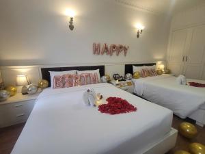Voodi või voodid majutusasutuse Luxor Boutique Hotel toas