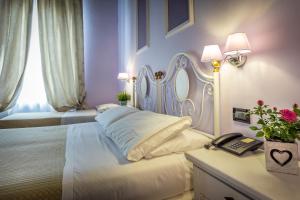 Postel nebo postele na pokoji v ubytování Hotel Ferrucci
