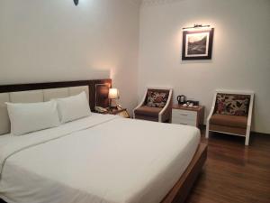 Voodi või voodid majutusasutuse Luxor Boutique Hotel toas