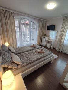 a bedroom with a large bed with two towels on it at Карпатська Вершина in Yaremche