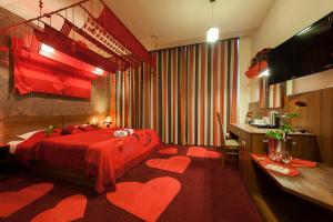 a hotel room with a bed with two hearts on the floor at Hotel Alexander in Krakow