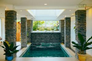 a swimming pool in a house with a window at Solara Boracay Villa in Boracay