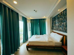 a bedroom with a bed and a window with green curtains at Solara Boracay Villa in Boracay +29 photos