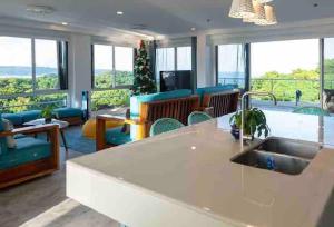 a kitchen and living room with a view of the ocean at Solara Boracay Villa in Boracay