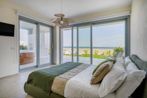 a bedroom with a bed with a view of the ocean at Villa fronte mare in Bari