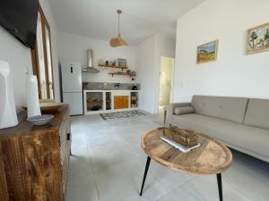 a living room with a couch and a table at Gaia Elysian Sea View New Golden Beach Piso Livadi in Kampos Paros
