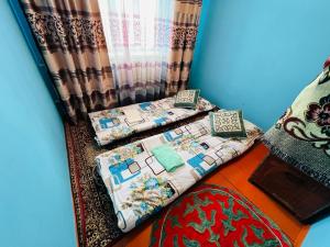 a room with two beds next to a curtain at Oroz Guest House in Jangy-Talap +20 photos