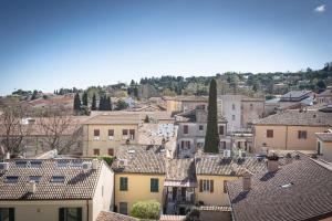 a view of a city with houses and roofs at Scalino 66 Suite del Teatro in Cesena