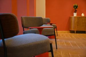 a waiting room with three chairs and a table at Landmark Hotel in Batumi