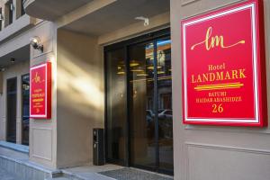 a red sign on the side of a building at Landmark Hotel in Batumi
