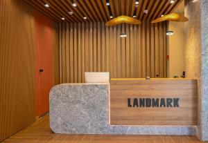 a lobby with a sign that reads landmark on a counter at Landmark Hotel in Batumi +78 photos
