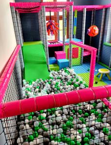 a play room with a playground with rocks and a playset at Pałac w Rymaniu in Rymań