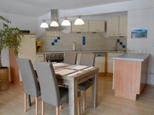 a kitchen with a wooden table and chairs at Haus Claudia in Reutte