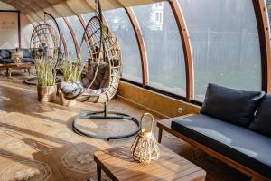 a living room with a couch and chairs and a table at Prawdzic Family Resort & Wellness in Gdańsk