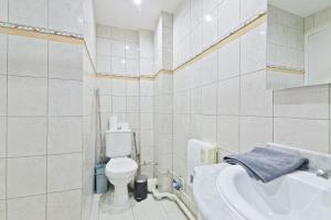 a white bathroom with a toilet and a sink at Studio Apartment Quartier Austerlitz Free Netflix in Paris