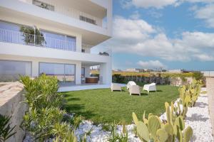a view of a house with chairs and a yard at Villa fronte mare in Bari