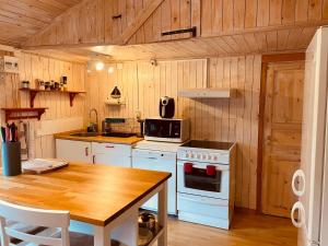 a kitchen with a stove and a table in it at Kosta Bed in Kosta