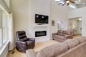 a living room with a couch and two chairs and a tv at Waterfront Retreat on Greers Ferry Lake with Hot Tub in Heber Springs