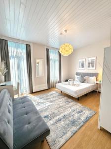a living room with a bed and a couch at Pensao Central in Matosinhos
