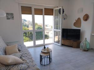 a living room with a couch and a television at CasaNani in Germignaga