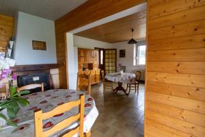 a bedroom with a bed and a table in a room at Gîte "La Partie de Bise", 12 personnes in Le Barboux