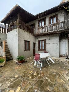 a patio with a table and chairs in front of a building at Aquanerius Résidence in Néris-les-Bains