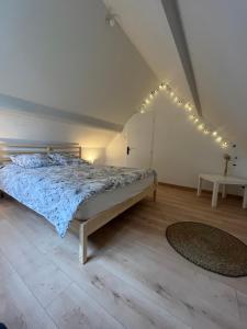 a bedroom with a bed with lights on the wall at Villa premium 150m de la plage in Barneville-Carteret