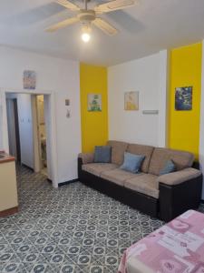 a living room with a couch and yellow walls at Apartment Lavanda in Pješčana Uvala