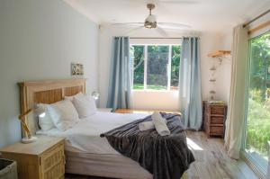 a bedroom with a bed and a window at Hermanus Josh in Hluhluwe