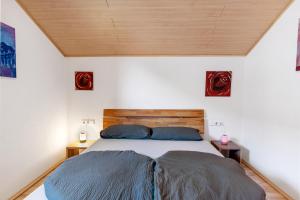 a bedroom with a bed and two night stands at Ferienwohnung Beni in Öhningen