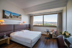 Postel nebo postele na pokoji v ubytování Hotel Minerva