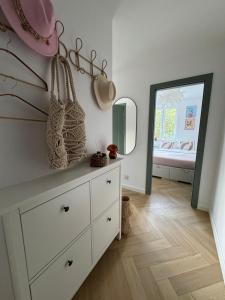 a white dresser in a room with a mirror at Studio 77 - nowoczesny apartament w Otwocku in Otwock +23 photos