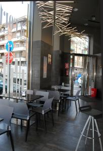 a restaurant with tables and chairs and a stop sign at Hostal La Cortijana in Logroño