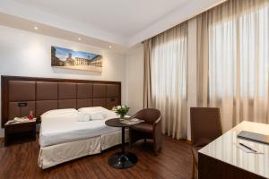 Postel nebo postele na pokoji v ubytování Hotel Minerva