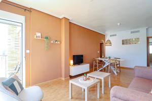 a living room with a couch and a tv at Casa Joek in Los Alcázares