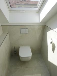 a small bathroom with a toilet and a skylight at Ferienwohnung Nr 3 Georg von Bach SKY TV in Deidesheim +10 photos