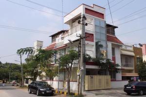 a building with cars parked in front of it at Abids Inn Homestay in Bangalore