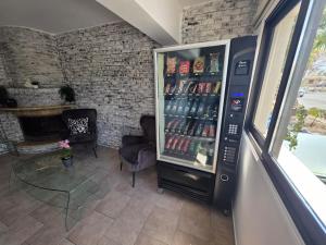 a vending machine in a room with a table and chairs at Town centre suites in Larnaca
