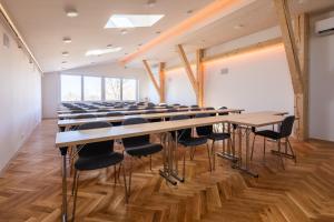 a large room with a long table and chairs at Retro Hotel JISKRA in Čeladná