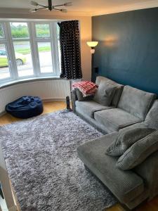 a living room with a couch and a rug at Beautiful Property Close To London in Potters Bar