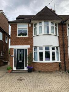 a brick house with a white door and windows at Beautiful Property Close To London in Potters Bar