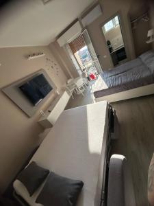 a room with a table and a bed and a television at work & relax home Milano bruzzano e fiera in Milan