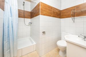 a bathroom with a toilet sink and a shower at Domki Leśne Uroczysko in Ustka +12 photos