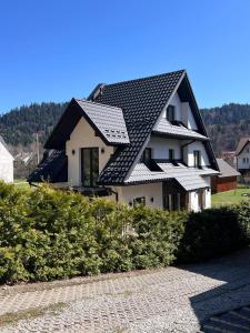 a house with a roof with solar panels on it at Willa Górski Relaks in Sromowce Niżne