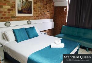 a hotel room with a bed and a couch at Marco Polo Motor Inn Sydney Hotel in Sydney