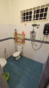 a bathroom with a toilet and a shower in it at Homestay ZaraMelly Kuala Terengganu in Kuala Terengganu +7 photos
