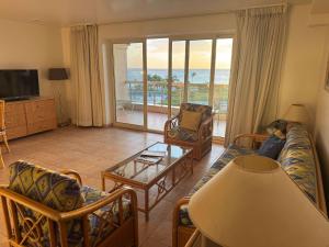 un soggiorno con un divano e un tavolo di Paradise Perch - Royal Retreats at Maho Beach a Lowlands