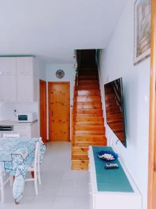 a room with a staircase with a table and a table sidx sidx at Via Luigi Einaudi 53- Guest House in Pedaso